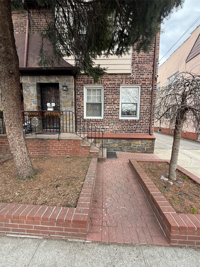 view of front facade featuring stone siding and brick siding