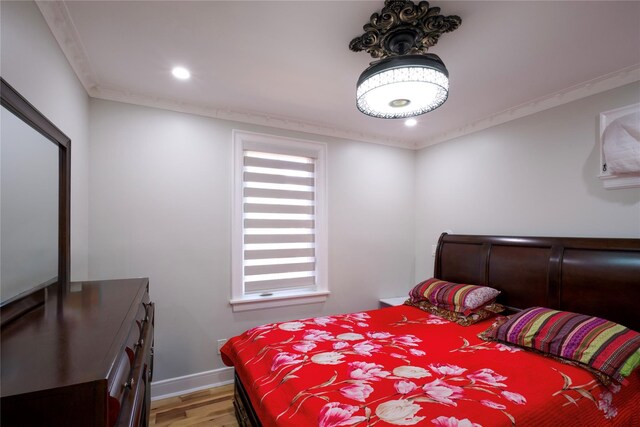 bedroom featuring light wood-type flooring, recessed lighting, ornamental molding, and baseboards
