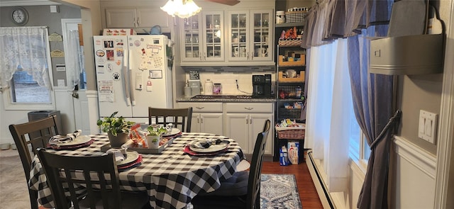 dining room with baseboard heating and wood finished floors