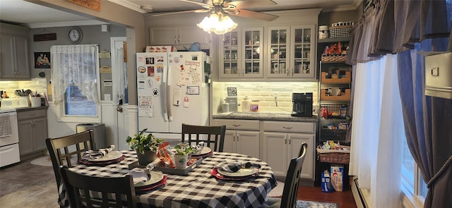 dining space with ceiling fan and ornamental molding