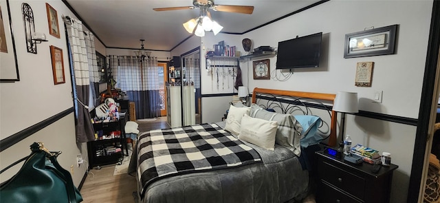 bedroom with ornamental molding, a ceiling fan, and wood finished floors