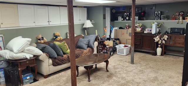 finished basement featuring a paneled ceiling and light colored carpet