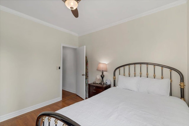 bedroom with ornamental molding, a ceiling fan, baseboards, and wood finished floors