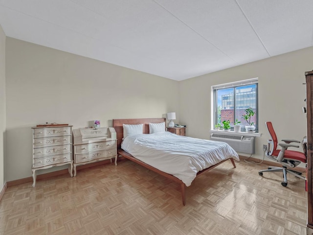 bedroom with a wall mounted AC and baseboards