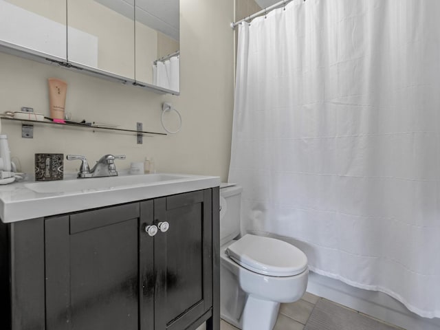 full bathroom with a shower with curtain, vanity, toilet, and tile patterned floors