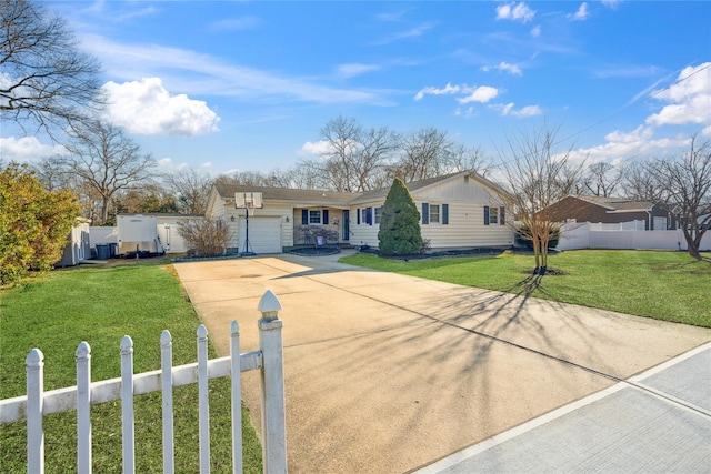 ranch-style house with a fenced front yard, board and batten siding, a garage, driveway, and a front lawn