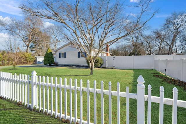 view of yard featuring a fenced backyard and a gate