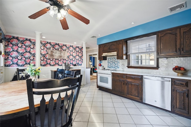 kitchen featuring white range with gas stovetop, visible vents, dishwasher, wainscoting, and light countertops