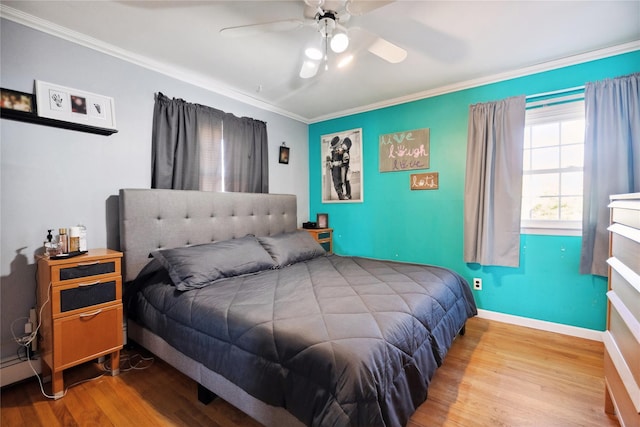 bedroom with ornamental molding, baseboards, and wood finished floors