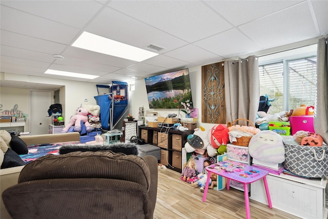 game room featuring visible vents, a drop ceiling, and wood finished floors