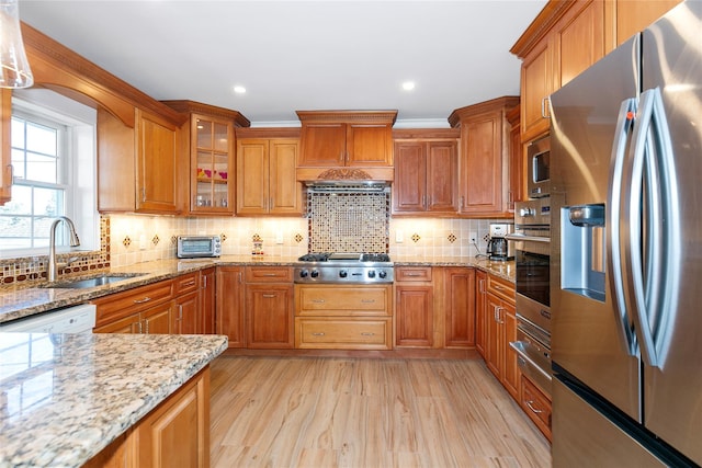 kitchen with brown cabinets, stainless steel appliances, and a sink