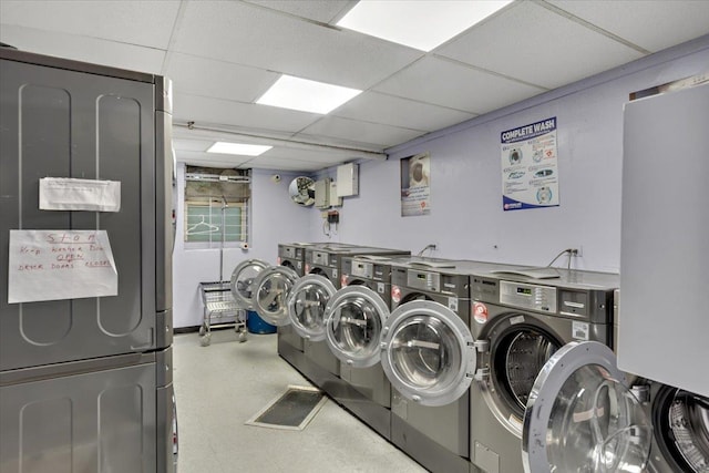 community laundry room featuring washing machine and clothes dryer and tile patterned floors