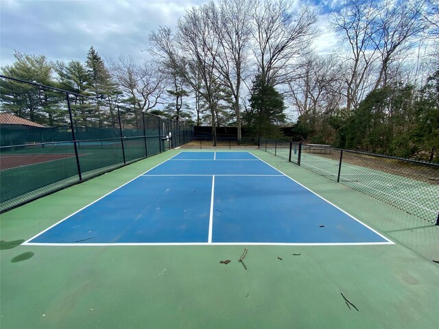 view of sport court featuring fence