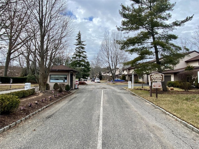 view of road with curbs and traffic signs