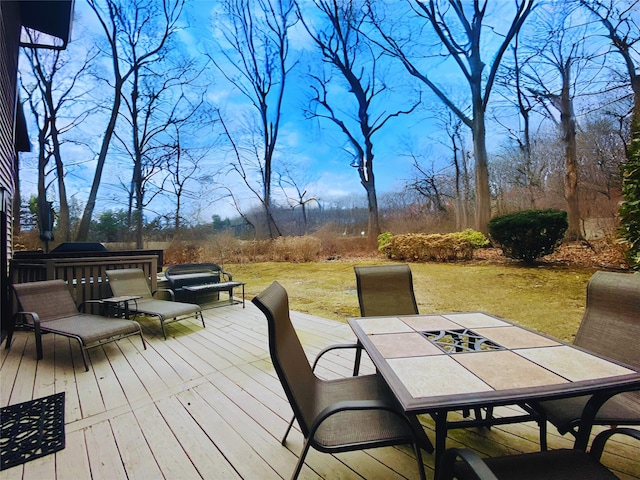 wooden deck featuring outdoor dining area