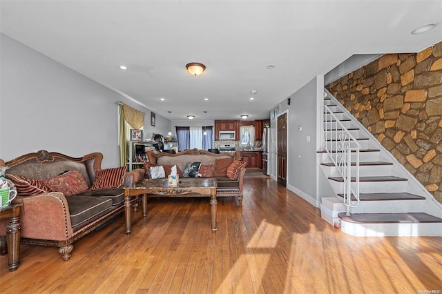 living area featuring stairs, hardwood / wood-style floors, baseboards, and recessed lighting