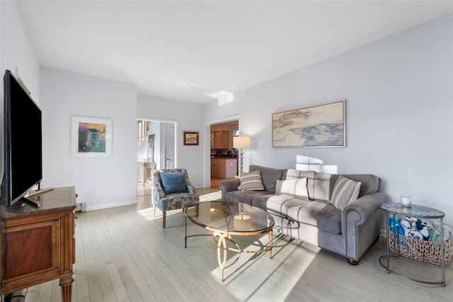 living room with light wood-style flooring and baseboards