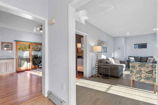 living area with a baseboard radiator and hardwood / wood-style flooring