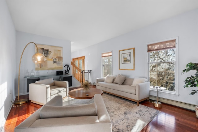 living room with a baseboard heating unit, stairway, and wood finished floors