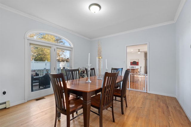 dining room with light wood-style floors, visible vents, ornamental molding, and baseboards