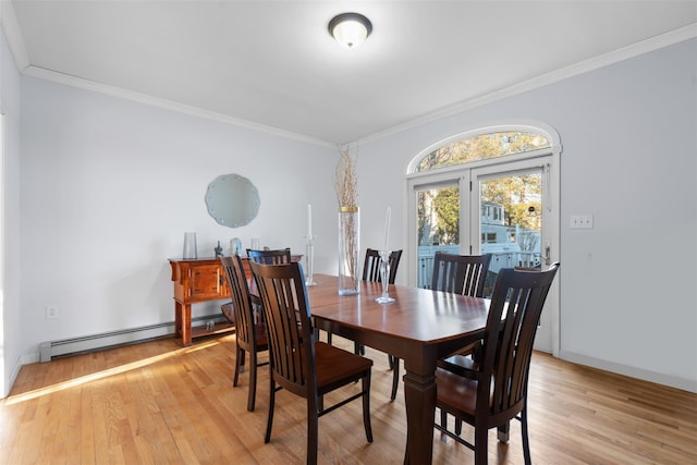 dining area with light wood finished floors, ornamental molding, and a baseboard heating unit