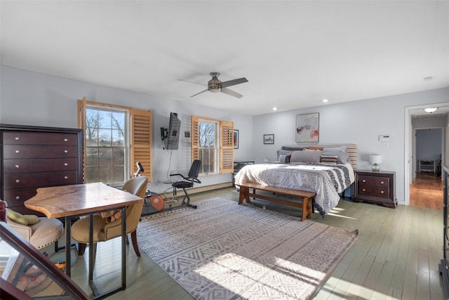 bedroom featuring a ceiling fan, wood finished floors, and recessed lighting