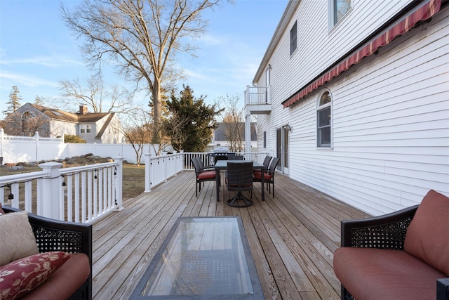 wooden terrace featuring outdoor dining area and fence