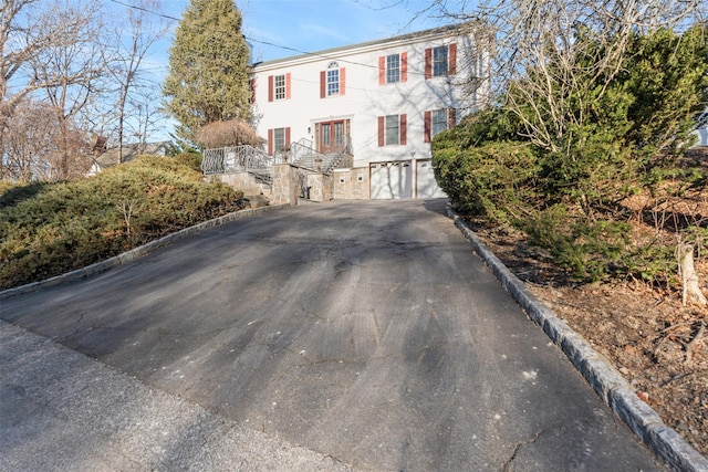 colonial house with driveway and an attached garage