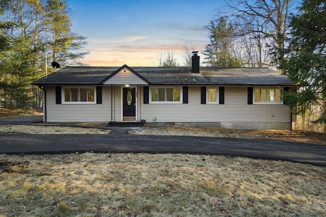 single story home featuring a chimney