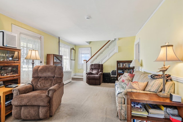 living area with carpet flooring and stairs