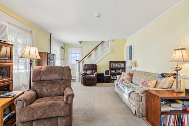 carpeted living area with crown molding and stairway