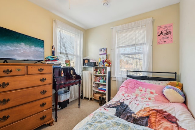 carpeted bedroom with radiator heating unit