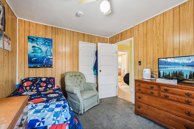 bedroom featuring wooden walls and carpet flooring