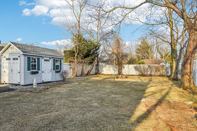 view of yard with an outbuilding and a fenced backyard