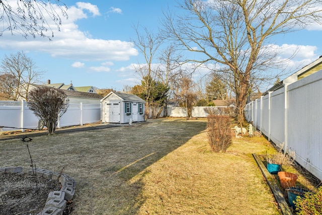 view of yard with an outdoor structure and a fenced backyard