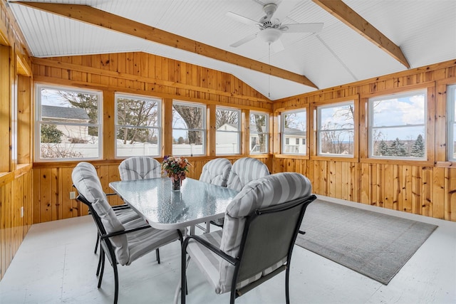 sunroom / solarium featuring lofted ceiling with beams and a ceiling fan