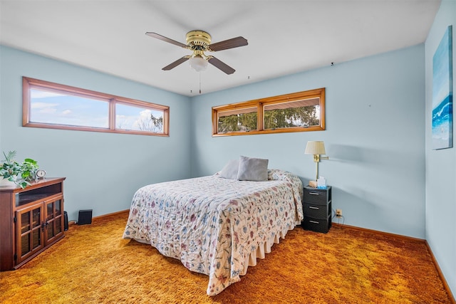 carpeted bedroom featuring ceiling fan and baseboards