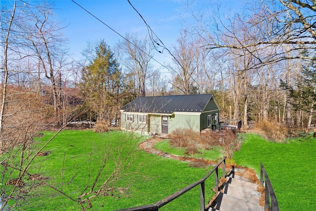 exterior space with a yard and metal roof