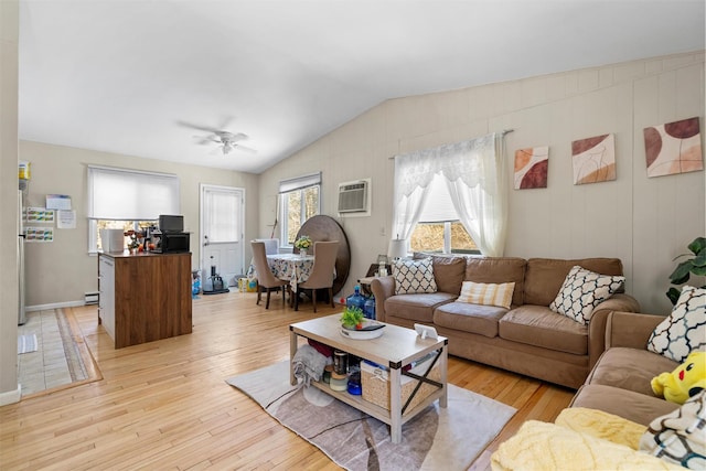 living room with light wood-style flooring, a ceiling fan, lofted ceiling, and a wall unit AC