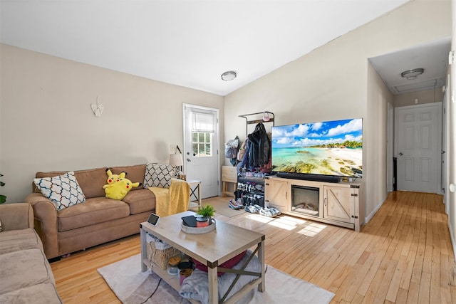 living area featuring attic access and light wood-style floors