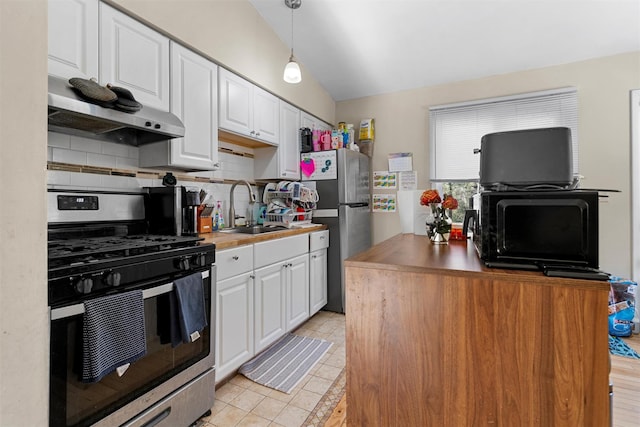 kitchen with lofted ceiling, a sink, stainless steel appliances, white cabinets, and under cabinet range hood