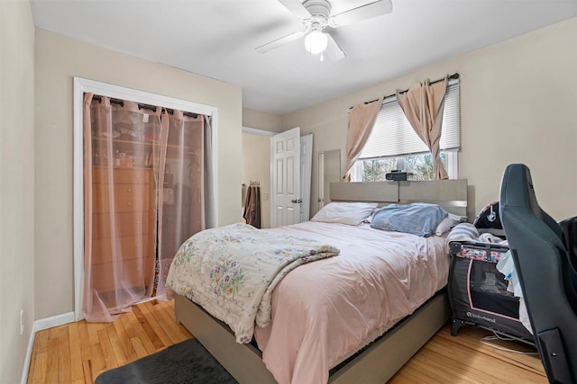 bedroom with light wood finished floors, baseboards, and a ceiling fan