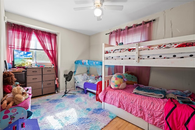 bedroom featuring a ceiling fan and wood finished floors