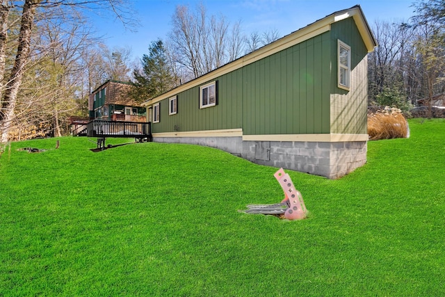 view of home's exterior with a lawn and a deck