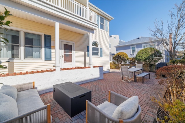 view of patio / terrace featuring an outdoor hangout area, outdoor dining space, and a balcony