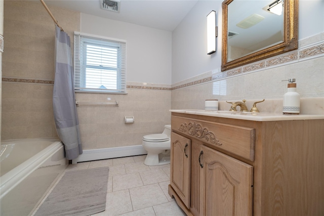 bathroom featuring toilet, tile walls, visible vents, baseboard heating, and tile patterned floors