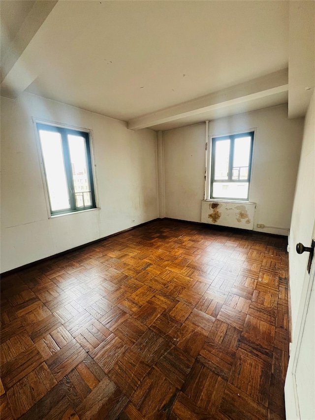 spare room featuring baseboards