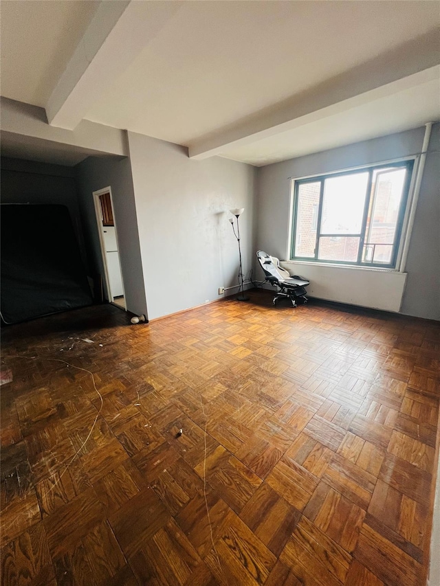 spare room featuring beamed ceiling