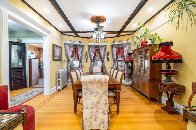 dining space featuring baseboards, coffered ceiling, beamed ceiling, and light wood finished floors