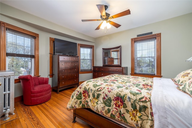 bedroom with a ceiling fan and wood finished floors